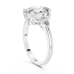 Silver ring with a oval-shaped center stone on a white background 