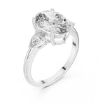 Silver ring with a oval-shaped center stone on a white background 