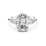 Silver ring with a oval-shaped center stone on a white background 