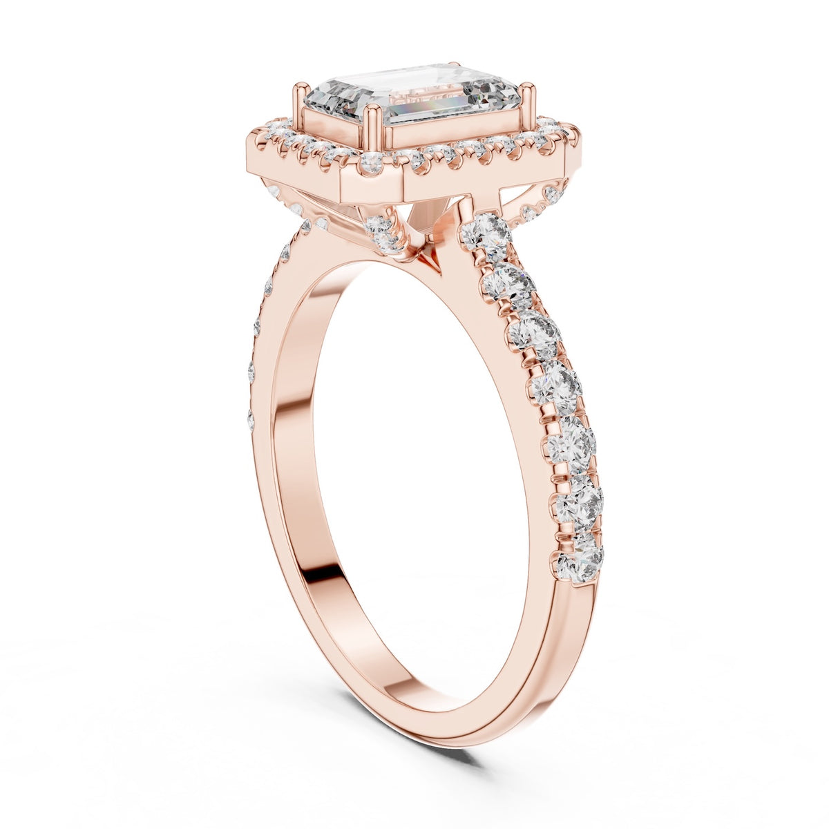 Rose-gold plated Silver ring with a central emerald-cut stone and halo on a white background 