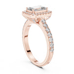 Rose-gold plated Silver ring with a central emerald-cut stone and halo on a white background 