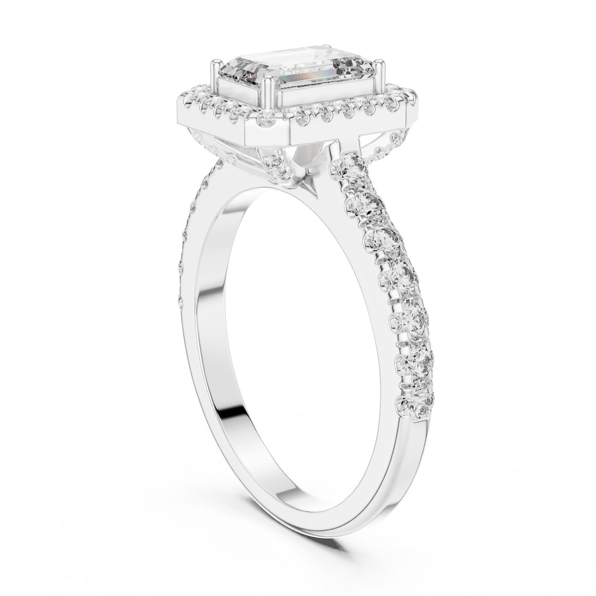 Silver ring with a central emerald-cut stone and halo on a white background 