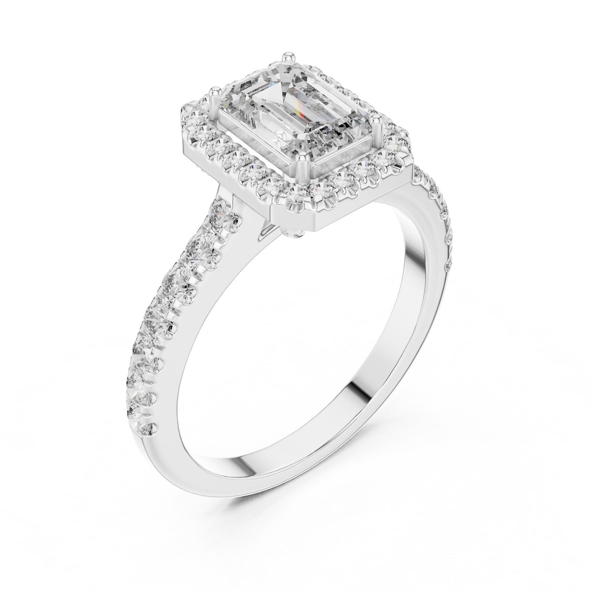 Silver ring with a central emerald-cut stone and halo on a white background 