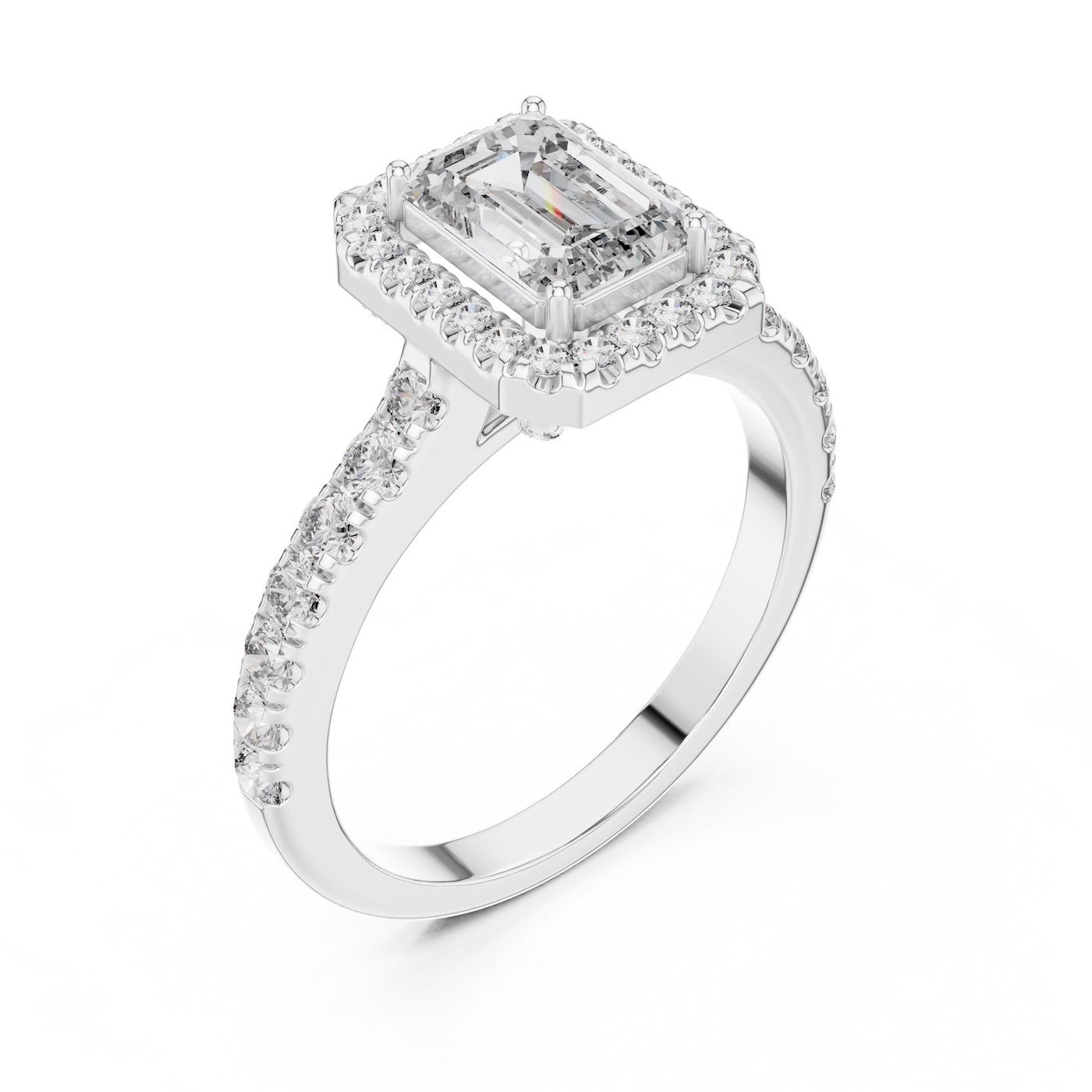 Silver ring with a central emerald-cut stone and halo on a white background 