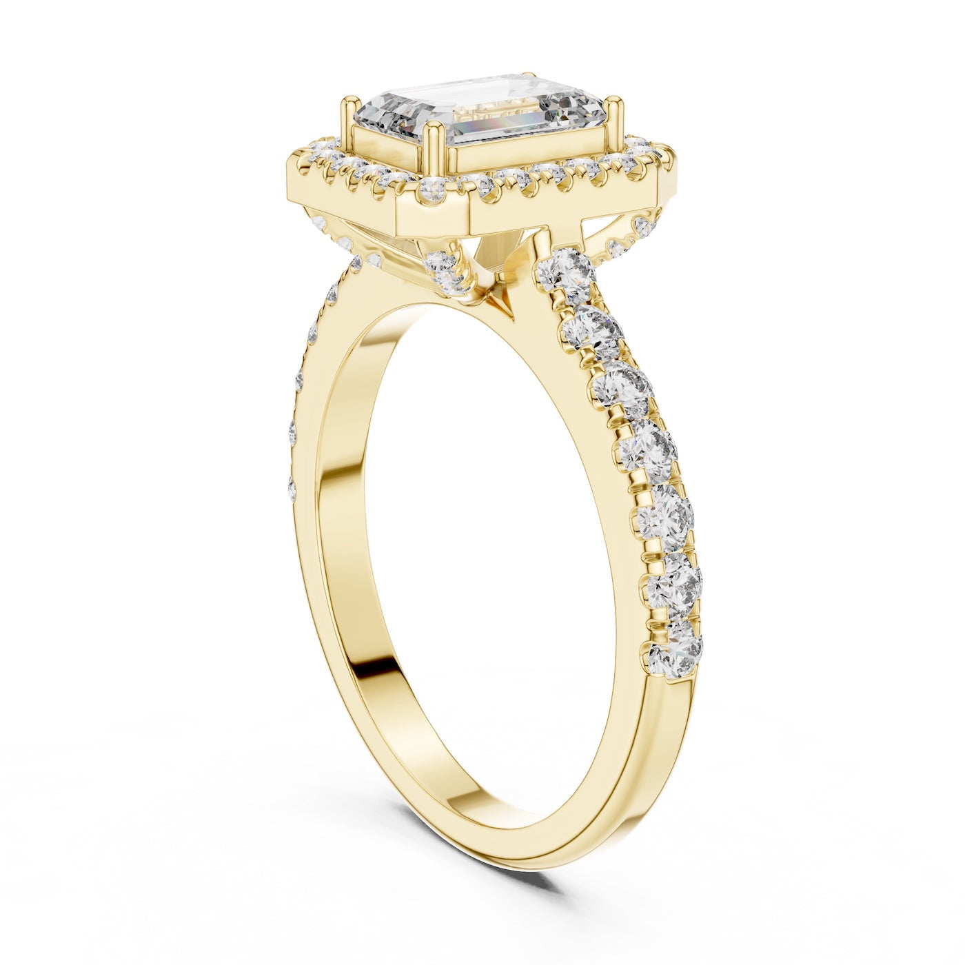 gold plated Silver ring with a central emerald-cut stone and halo on a white background 