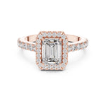 Rose-gold plated Silver ring with a central emerald-cut stone and halo on a white background 