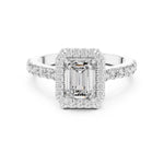 Silver ring with a central emerald-cut stone and halo on a white background 