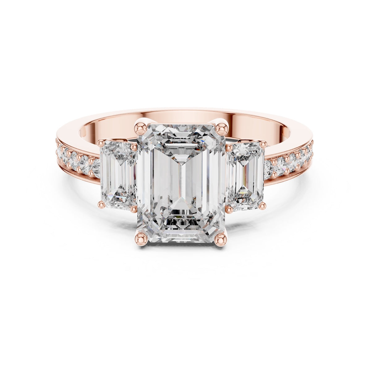 Rose-gold plated Silver ring with three emerald-cut center stones and smaller round stones on a white background 