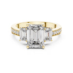 Gold plated Silver ring with three emerald-cut center stones and smaller round stones on a white background 