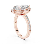 Rose-gold plated silver ring with a pear-shaped center stone on a white background 
