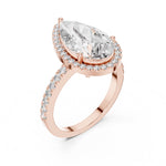 Rose-gold plated silver ring with a pear-shaped center stone on a white background 