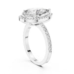 Silver ring with a pear-shaped center stone on a white background 