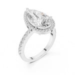 Silver ring with a pear-shaped center stone on a white background 