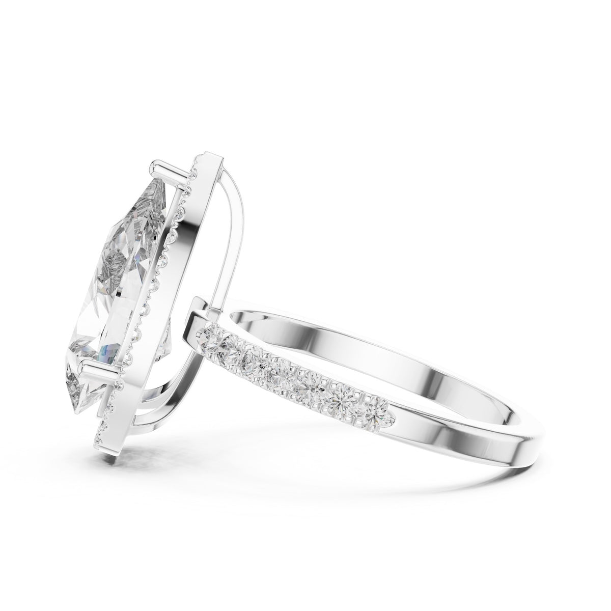 Silver ring with a pear-shaped center stone on a white background 