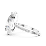 Silver ring with a pear-shaped center stone on a white background 