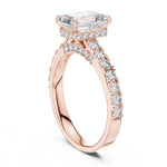 Rose-gold plated Silver ring with a central emerald-cut diamond and smaller diamonds on a white background 