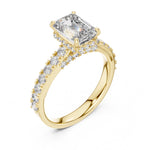 gold plated Silver ring with a central emerald-cut diamond and smaller diamonds on a white background 