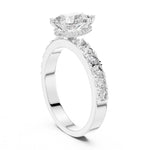 Silver ring with a pear-shaped center stone on a white background 