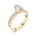 gold plated silver ring with a pear-shaped center stone on a white background 