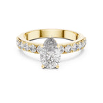 gold plated silver ring with a pear-shaped center stone on a white background 