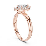 Rose-gold plated silver ring with pear-shaped center stone on a white background 