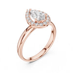 Rose-gold plated silver ring with pear-shaped center stone on a white background 