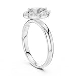 Silver ring with pear-shaped center stone on a white background 