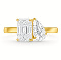 Two stone diamond ring in yellow gold seen end-on, radiant cut and pear cut lab grown diamonds side by side